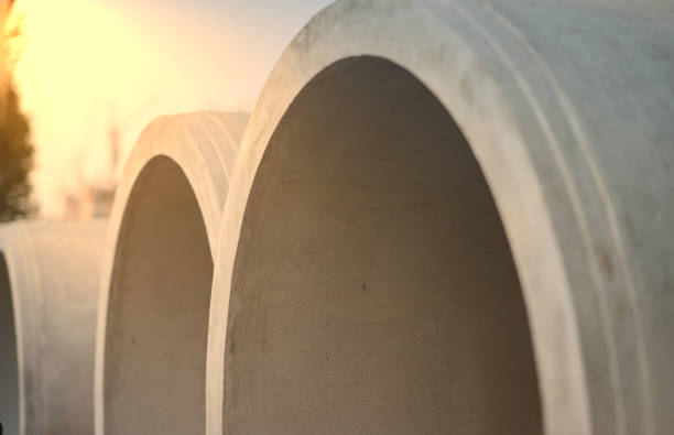 Big cement pipes in stack ,closed up with sunflare stock photo