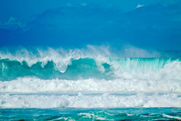 Big Crashing Waves Big Crashing Waves with Vibrant Blue pantone adulation photos stock pictures, royalty-free photos & images