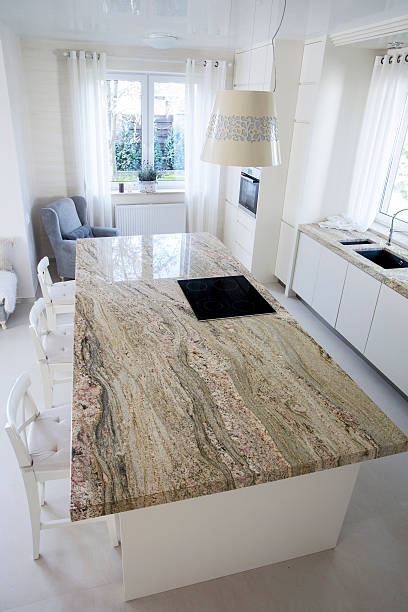Big granitic worktop in bright kitchen Big granitic worktop in bright kitchen, vertical granitic stock pictures, royalty-free photos & images