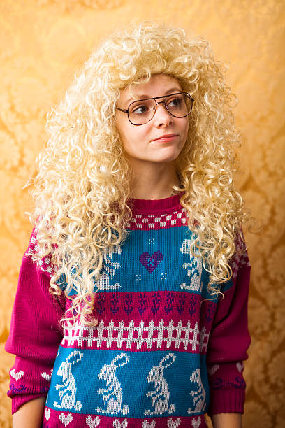 Big hair woman spacing out "A young from the late 1980s or early 1990s with large hair and ugly sweater looking off into space. She is totally unaware of reality, she is off thinking in her own wonderland. ++ Shot on January 28th, 2012 with a Canon 5d mark II and 85mm lens. Vintage yellow background used.More of this model:" ugly girl stock pictures, royalty-free photos & images