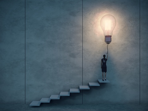 Business woman climbing up the stairs and putting on the light bulb. Can be used big idea, innovation, leadership concepts.  (3d render)