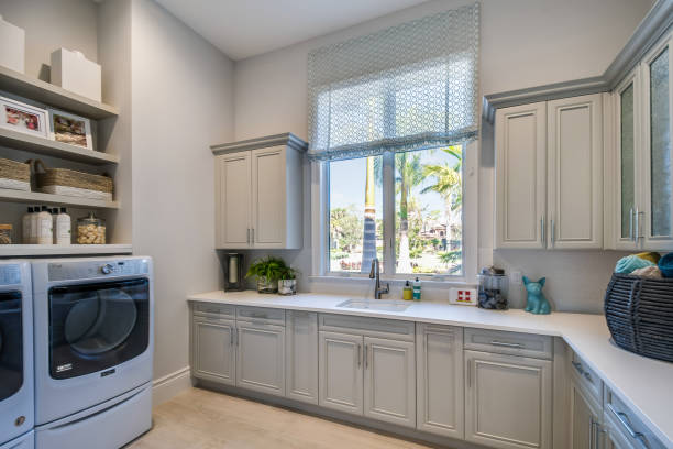 Big laundry room with plenty of cabinets and shelves for all your needs Luxury of being able to do multiple things in this excellent utility space dryer photos stock pictures, royalty-free photos & images