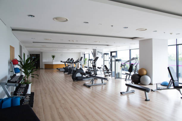Big light gym with sports equipment in hotel stock photo