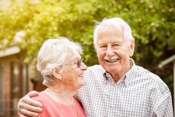 Big Love Lovley sweet old couple laughing stand side by side mid adult couple stock pictures, royalty-free photos & images