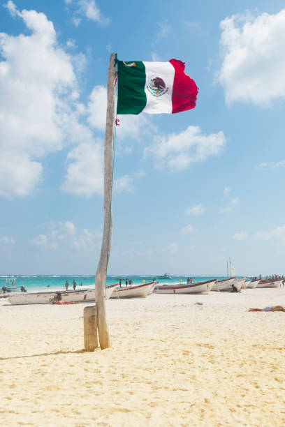 Big mexican flag in caribbean relax beach stock photo