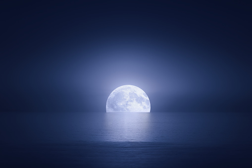 big moon over the sea at night