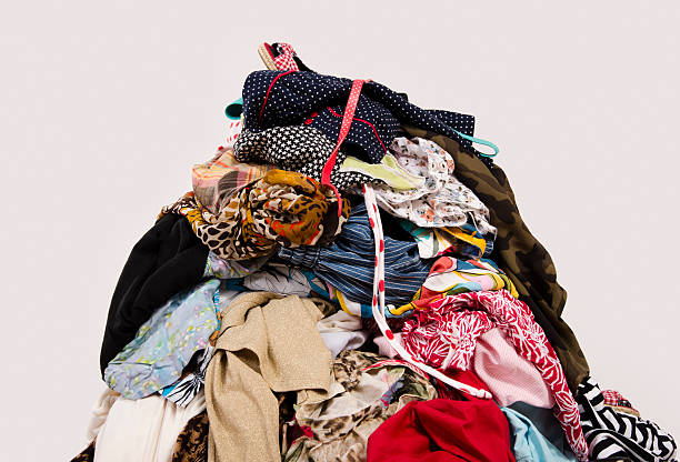 Big pile of clothes and accessories thrown on the floor. stock photo