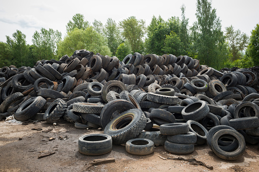 A large pile of old tires, representing a variety of brands, at Raadi Airfield in Tartu, Estonia. The airfield was once a major Soviet air force base.