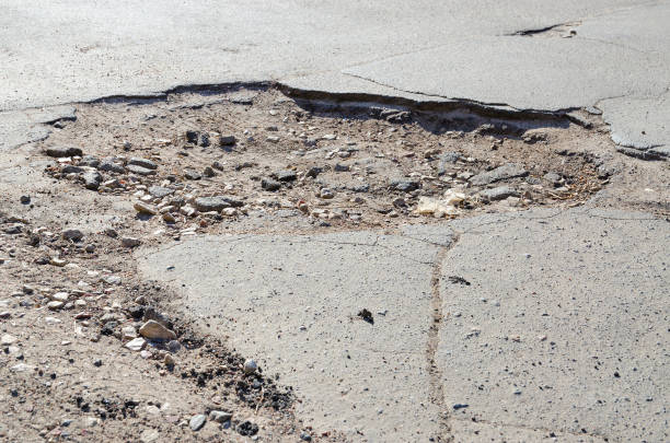 Big pothole on asphalt road stock photo