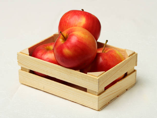 Big red apples in wooden box. stock photo