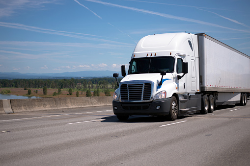 Big Rig White Semi Truck With Dry Van Trailer Moving On Big Rig White Semi Truck With Dry Van Trailer Moving On