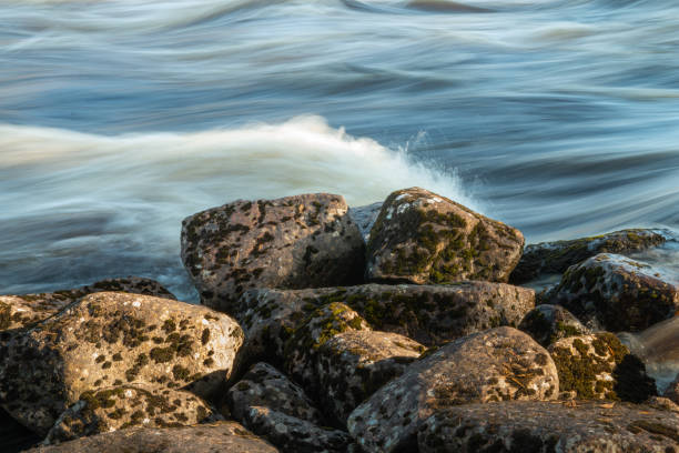 Big rocks by the river with rapids stock photo