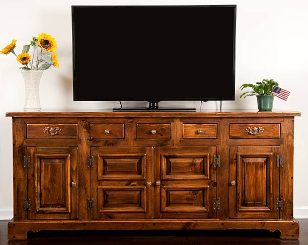 Big Screen TV sitting a colonial style wood cabinet Big Screen TV sitting a colonial style wood cabinet. Image shot with, Canon 5D Mark2 , 100 ISO, 24-115mm lens and studio strobes. dresser photos stock pictures, royalty-free photos & images