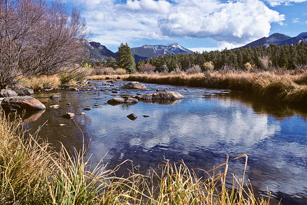 Big Thompson River and Twin Sisters Peak The Big Thompson River is a 78 mile tributary of the South Platte River in Colorado. The headwaters of the Big Thompson River begin in the Rocky Mountains near the Continental Divide at Forest Canyon. On July 31, 1976 the Big Thompson River was the site of a huge flash flood that swept down the steep and narrow canyon, killing 143 people. The flood was triggered by a thunderstorm near the upper section of the canyon that dumped 12 inches of rain in less than 4 hours. Very little rain fell in the lower section of the canyon, where many of the victims were. The Big Thompson River was photographed as it meandered through Moraine Park in Rocky Mountain National Park near Estes Park, Colorado, USA. jeff goulden rocky mountain national park stock pictures, royalty-free photos & images