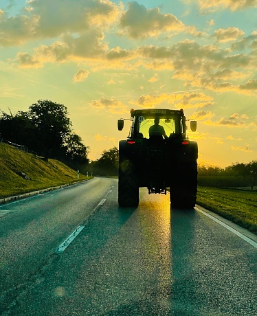 Big tractor ahead on the asphalt road