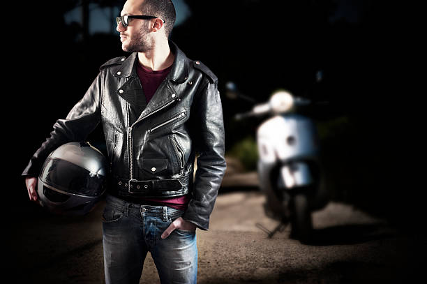 Biker in leather jacket and sunglasses stock photo