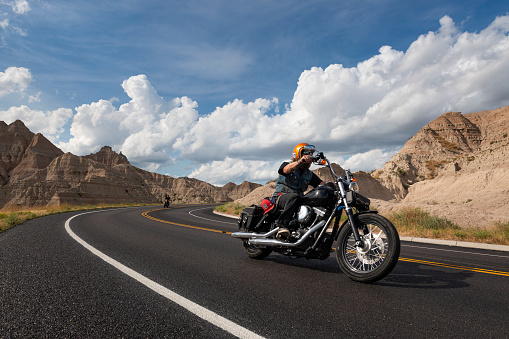 Badlands National Park, South Dakota - August 9, 2014: Bikers riding their chopper motorcycles on a road at the Badlands National Park.