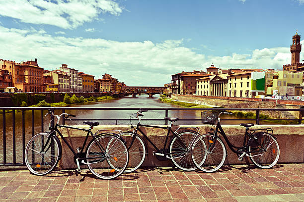 bikes in Florence , Italy three bikes photographed on the bridge over the River Arno , Florence , Italy  (vintage style) arno river stock pictures, royalty-free photos & images