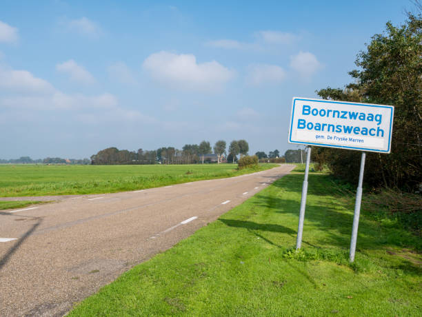 Bilingual place name sign in Frisian and Dutch of Boornzwaag by polder road, Friesland, Netherlands stock photo