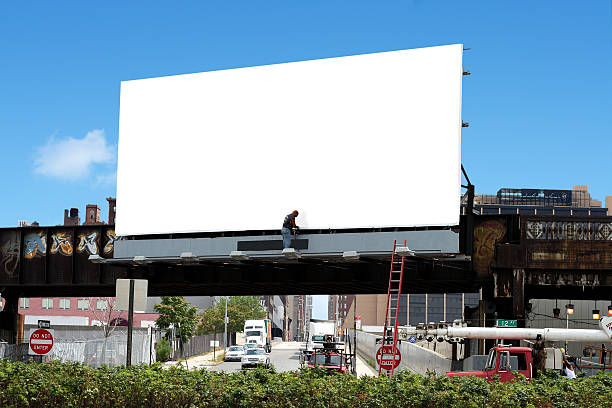 billboard and worker a man tends to a blank billboard in manhattan nyc billboard posting stock pictures, royalty-free photos & images