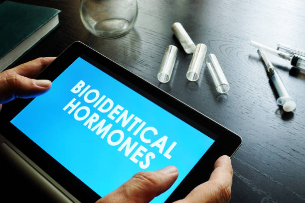 Bioidentical hormones. Doctor holding tablet with sign.  hormone stock pictures, royalty-free photos & images