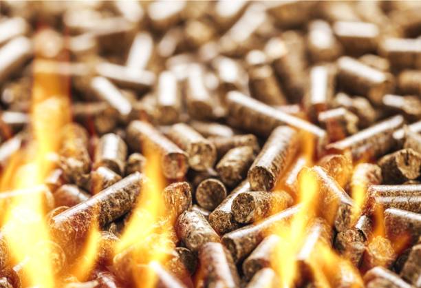 Biomass. burning wood chip pellets a renewable source granule stock pictures, royalty-free photos & images