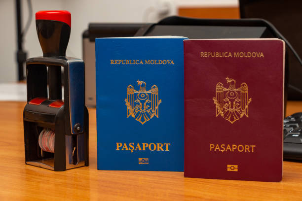 Biometric passports of citizens of the Republic of Moldova of red and blue colors with a date stamper. Covers of documents of different colors. Inscription - Republic of Moldova, Passport Biometric passports of citizens of the Republic of Moldova of red and blue colors with a date stamper. Covers of documents of different colors. Inscription - Republic of Moldova, Passport SA Rego Check stock pictures, royalty-free photos & images