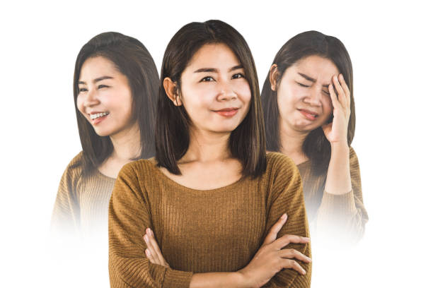 bipolar disorder Asian woman face happy smiling and depressed sad moods stock photo