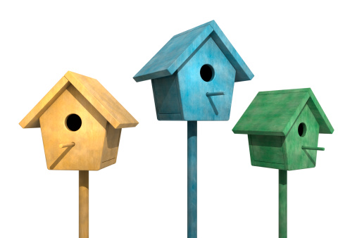 Colorful weathered Birdhouses in a row on a white background.Could be useful in a spring or bird composition.This is a detailed 3d rendering.