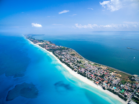 VARADERO, CUBA – MAY 25, 2016: Dron flies over tropical island on a clear day. Calm Atlantic Ocean and the bay. It is flying over the city. Height of 500 meters.