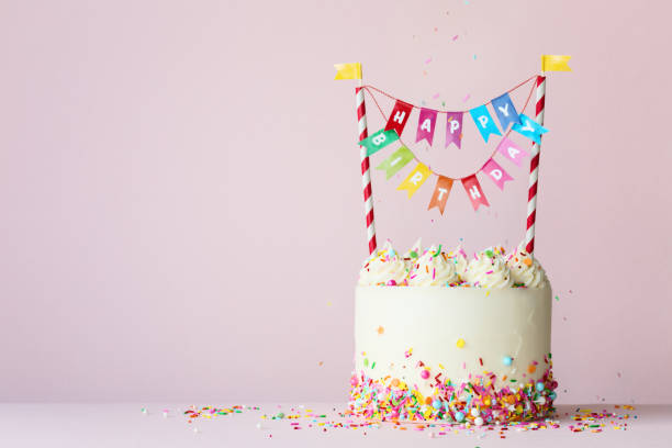 Birthday cake with colorful happy birthday banner Birthday cake with brightly colored happy birthday banner happy birthday words stock pictures, royalty-free photos & images