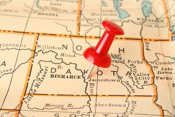Bismarck Pushpin pointing Bismarck city, North Dakota state capital, over more than fifty years old map north dakota stock pictures, royalty-free photos & images
