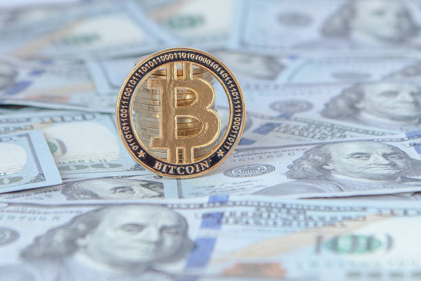Bitcoin against the background of dollar bills. exchange bitcoin for dollars. fall of bitcoin Bitcoin against the background of dollar bills. exchange bitcoin for dollars. fall of bitcoin. bitcoin usd stock pictures, royalty-free photos & images
