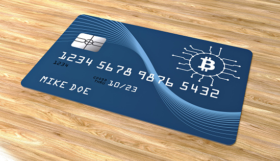 bitcoin credit card on wood background stock photo