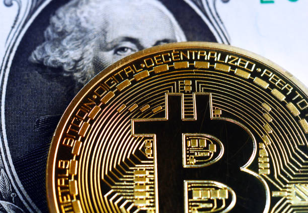 bitcoin on dollar bill stock photo