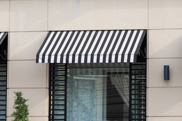 black and white awning over shop store window.  awning window stock pictures, royalty-free photos & images