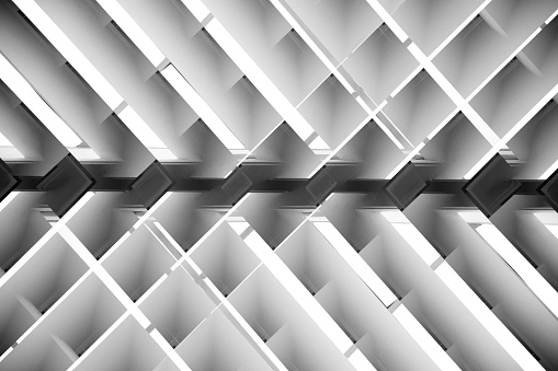 Brightly lit lath ceiling / roof. Abstract background photo on the subject of hi-tech architecture and interior.