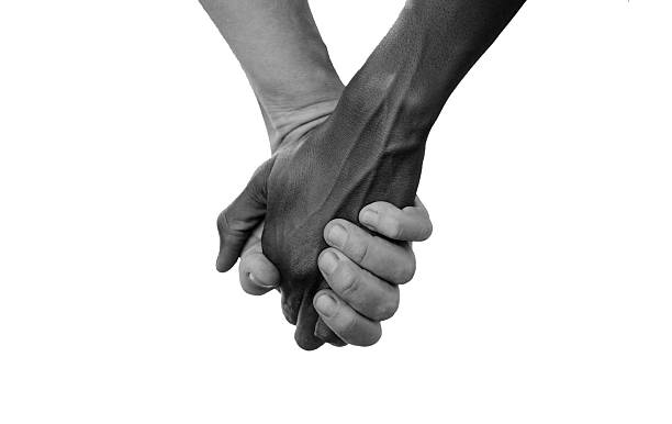 Black and White Hold Hands for Africa Union Peace Love stock photo