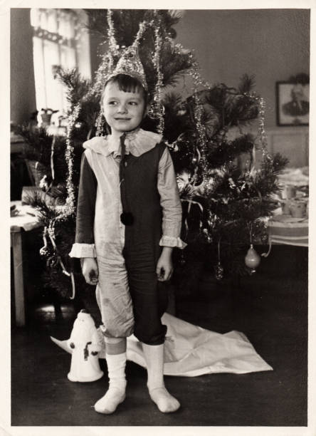 Black and white portrait of a little boy near a New Year tree. stock photo
