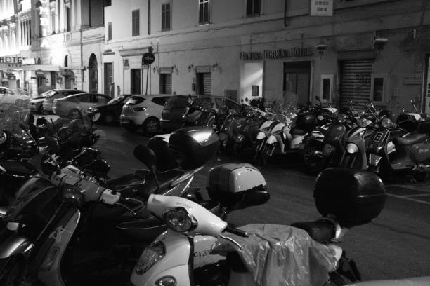 Black and white street Photography :  Vespa's parked on a street in Rome stock photo