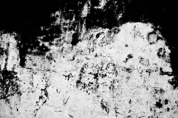 black and white texture of wall with paint peeling off stock photo