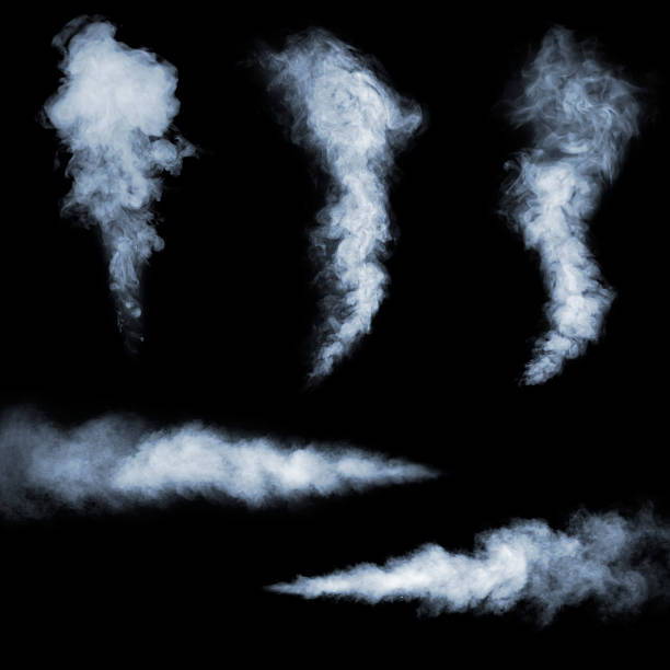 Black background with five clouds of white smoke stock photo
