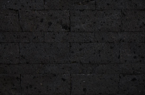 Black basalt stone wall texture Black basalt stone wall texture basalt stock pictures, royalty-free photos & images