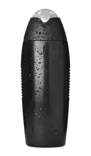 Black bottle covered with water drops isolated on white. Men's cosmetics