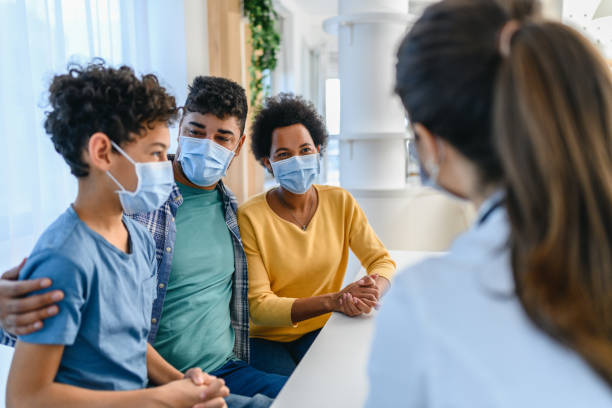 Black boy having a medical exam at doctor's office stock photo