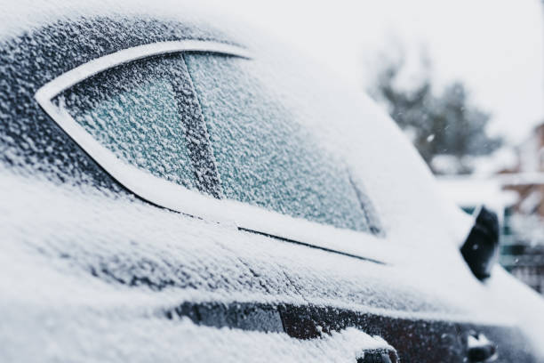 Black car covered in snow, ice on the windows stock photo