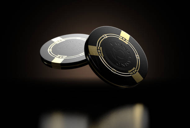 Black Casino Chips A set of two reflective black casino chips with gold markings floating in the air on a dark classy background - 3D render gambling chip stock pictures, royalty-free photos & images