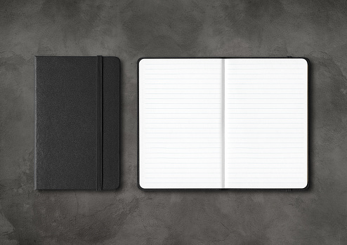 Black closed and open lined notebooks mockup isolated on dark concrete background