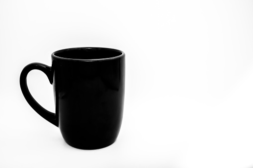 A black coffee cup on a white backdrop.