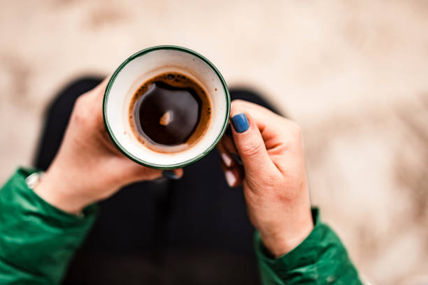 Black coffee in woman`s hands stock photo